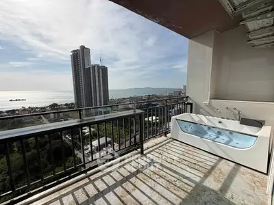 Luxurious balcony with stunning ocean view and private bathtub, perfect for relaxation.