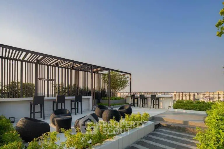 Stunning rooftop terrace with modern seating and panoramic city views.