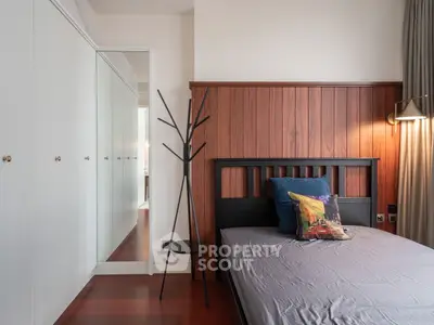 Modern bedroom with wooden paneling and sleek wardrobe design