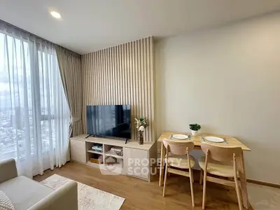 Modern living room with stylish TV unit and dining area, featuring floor-to-ceiling windows and elegant decor.