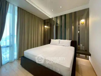 Modern bedroom with stylish decor and large window for natural light