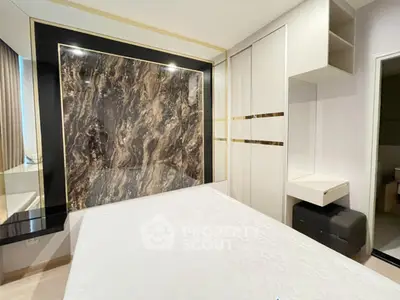 Luxurious bedroom with elegant marble accent wall and modern built-in storage solutions.