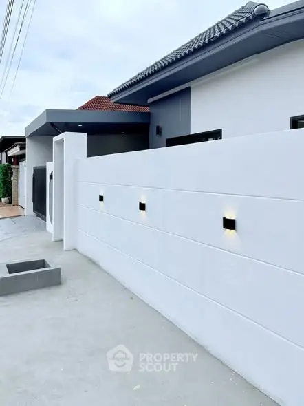 Modern house exterior with sleek white walls and contemporary lighting
