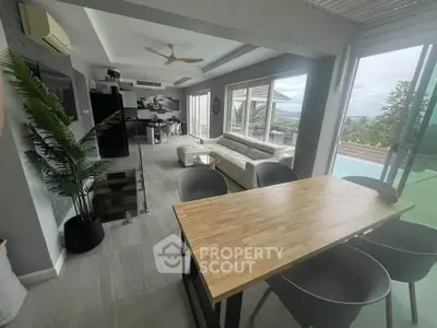 Modern open-plan living room with pool view and stylish decor