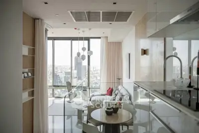 Luxurious modern living room with panoramic city view, open kitchen layout, and elegant decor.