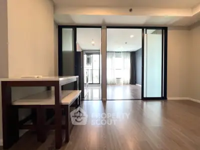 Spacious modern living area with wooden flooring and large windows