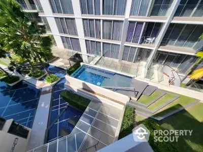 Modern apartment building with pool and lush greenery, perfect for urban living.