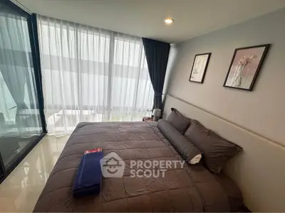 Modern bedroom with large windows and stylish decor