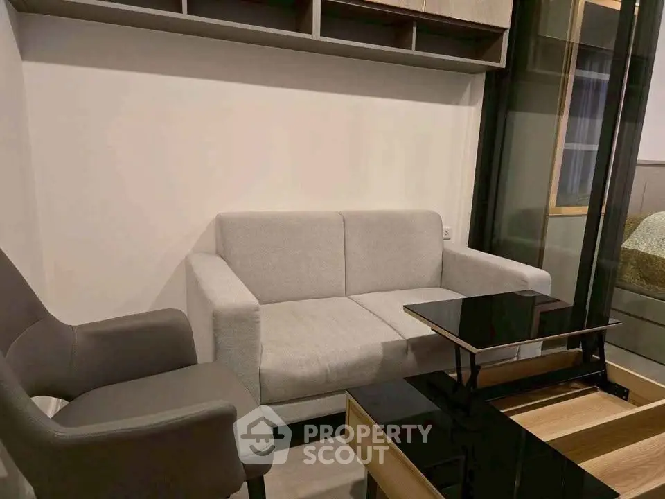 Modern living room with cozy gray sofa and sleek black coffee table