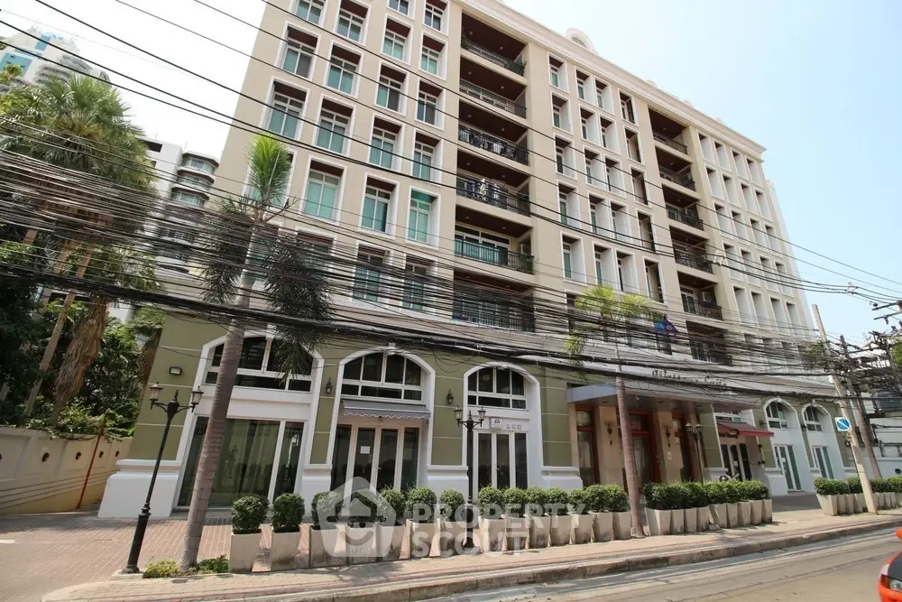 Elegant multi-story building with modern facade and lush greenery