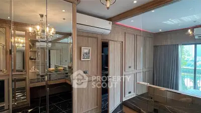 Luxurious study room with elegant wood paneling and mirrored accents, featuring a large window with natural light.