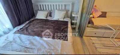 Cozy bedroom with modern decor and natural light, perfect for relaxation and comfort.