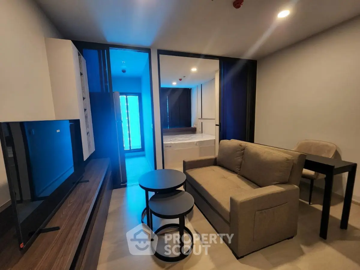 Modern living room with sleek furniture and open layout in a stylish apartment.