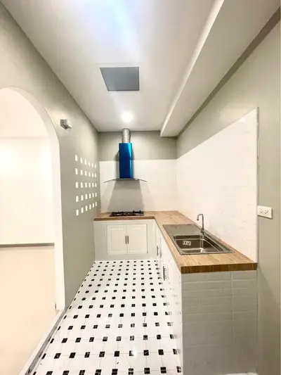 Modern kitchen with sleek design, gas stove, and stylish backsplash.