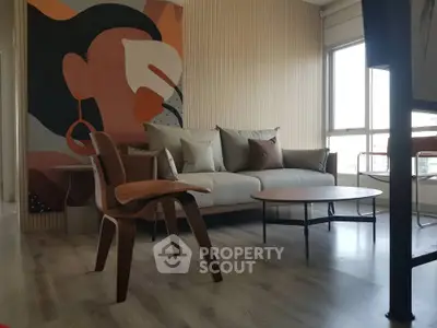 Stylish living room with modern art, cozy sofa, and elegant wooden chair, perfect for urban living.