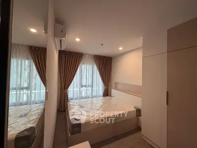 Modern bedroom with large window and stylish curtains in a cozy apartment.