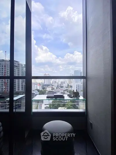 Stunning cityscape view from a modern high-rise balcony with glass railing.