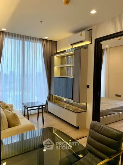Modern living room with floor-to-ceiling windows and stylish furniture in a high-rise apartment.