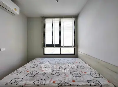 Cozy bedroom with large window and air conditioning, perfect for relaxation.