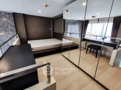 Modern bedroom with mirrored wardrobe and sleek design