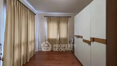 Spacious room with elegant curtains and modern wardrobe