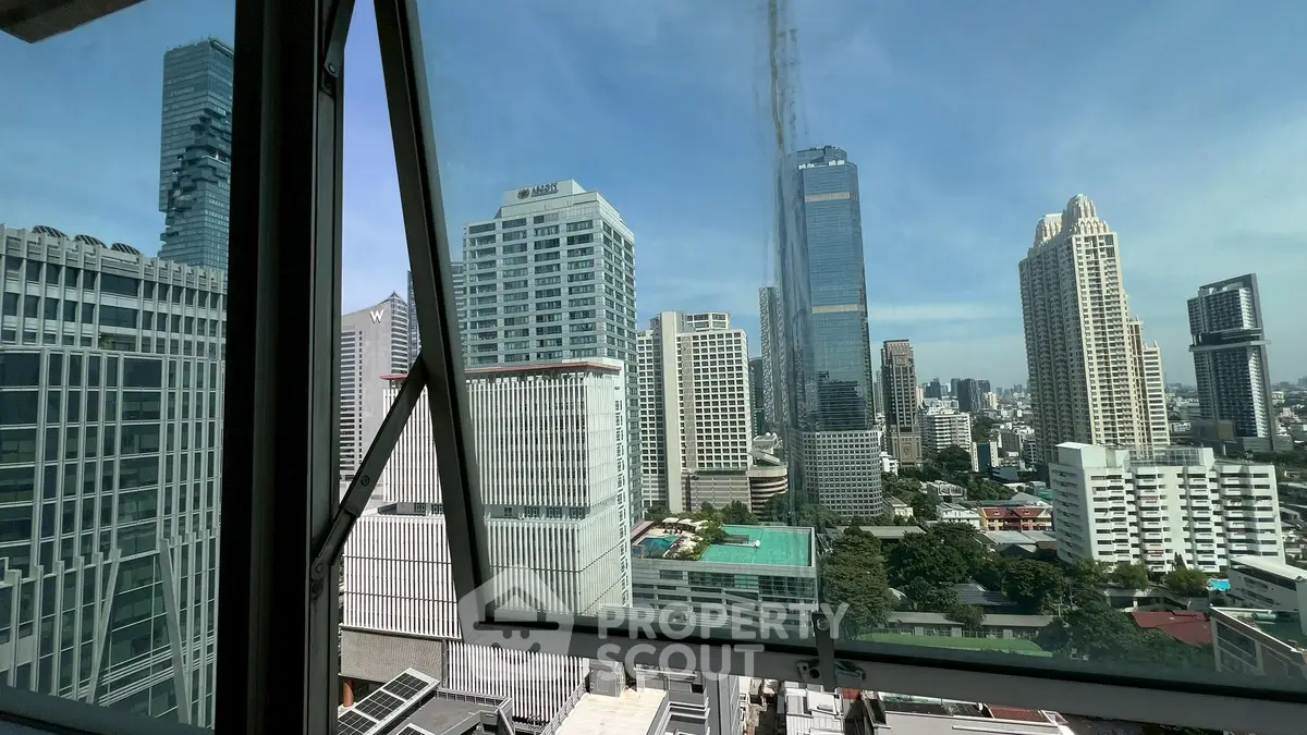 Stunning cityscape view from a high-rise building window showcasing modern skyscrapers.