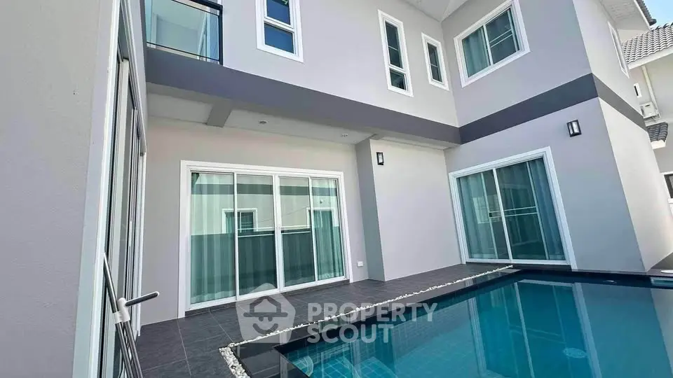 Modern two-story home with private pool and sleek architectural design.