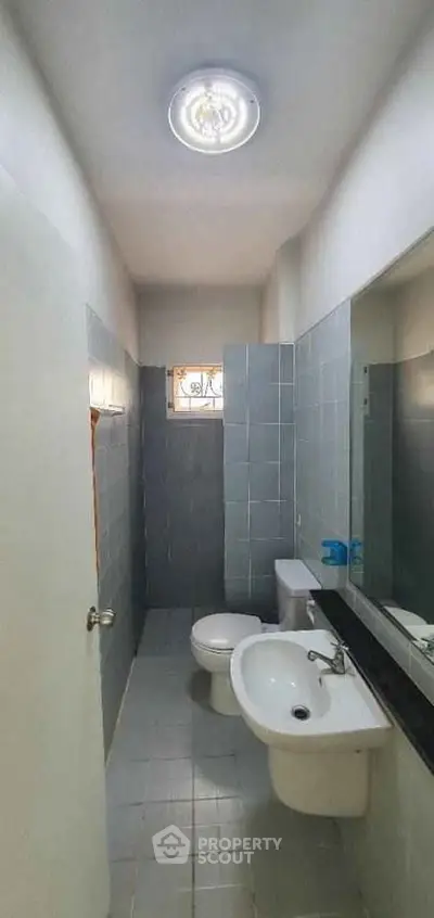 Compact bathroom with modern fixtures and natural light