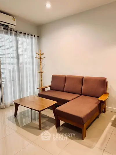 Cozy living room with modern sofa and coffee table, perfect for relaxation.