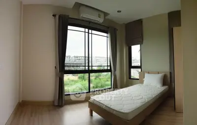 Modern bedroom with large windows and natural light in urban apartment