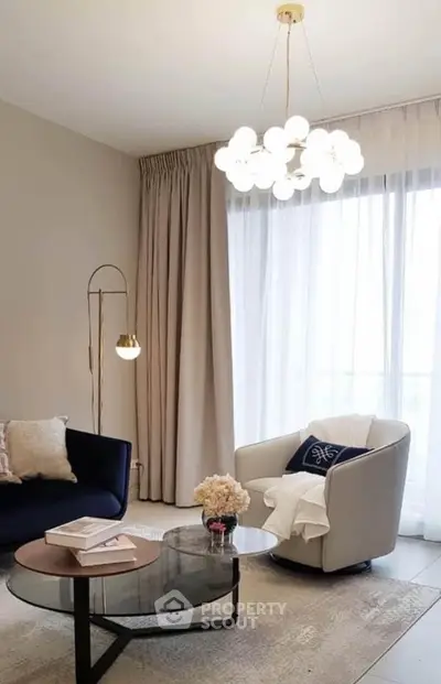 Elegant living room with modern chandelier and cozy seating area