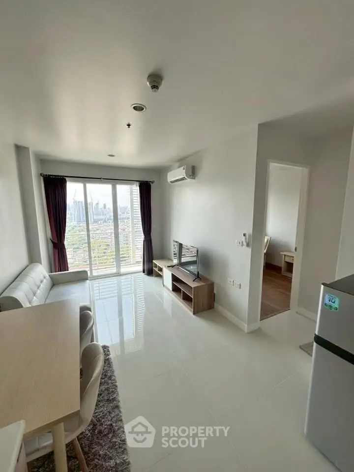 Modern living room with city view, sleek furniture, and natural light.