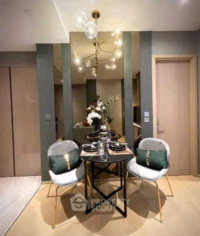 Elegant dining area with modern chandelier and stylish decor in a contemporary apartment.