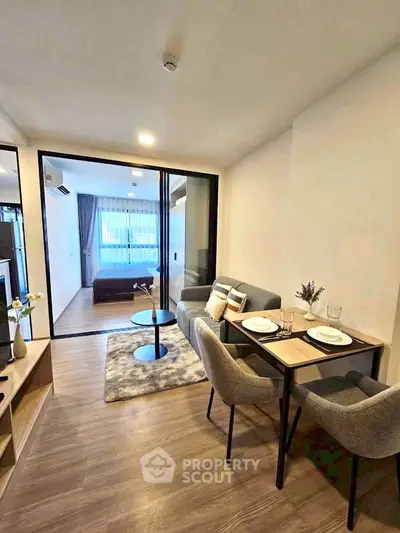 Modern open-plan living and dining area with cozy seating and stylish decor