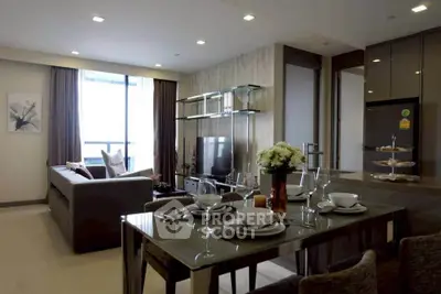 Modern living room with elegant dining area and large window view in a stylish apartment.