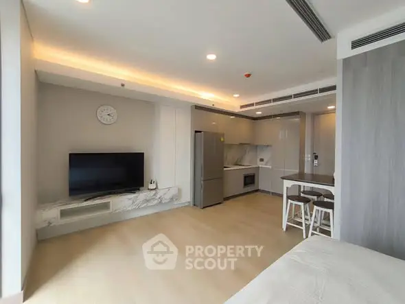 Modern open-layout living room with sleek kitchen and stylish decor