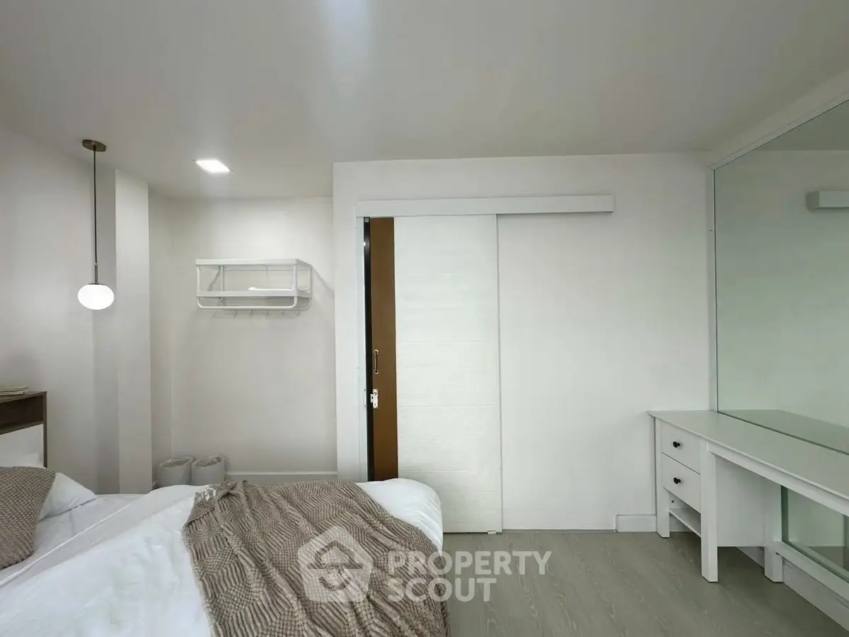 Modern minimalist bedroom with sliding door and elegant decor