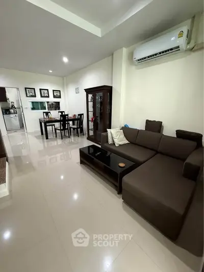 Spacious living room with modern furniture and open dining area