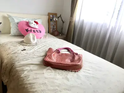 Cozy bedroom with plush decor and ample natural light, perfect for relaxation and comfort.