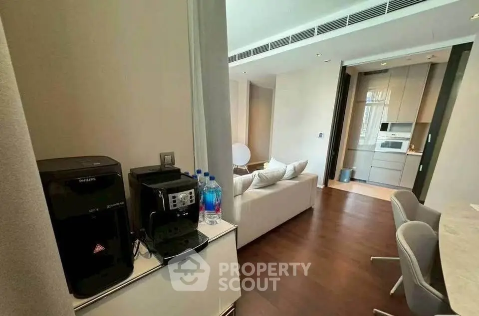 Modern open-plan living room with sleek kitchen and cozy seating area