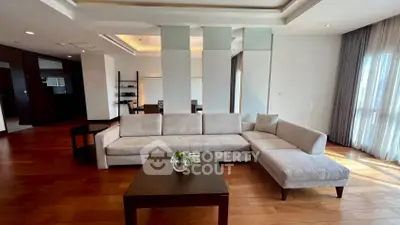 Spacious modern living room with elegant sofa and wooden flooring