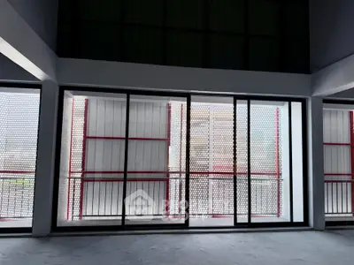 Spacious modern balcony with large sliding glass doors and stylish metal railing.