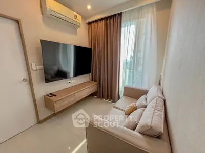 Modern living room with sleek TV setup and cozy seating area