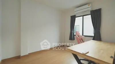 Bright study room with wooden desk and modern air conditioning