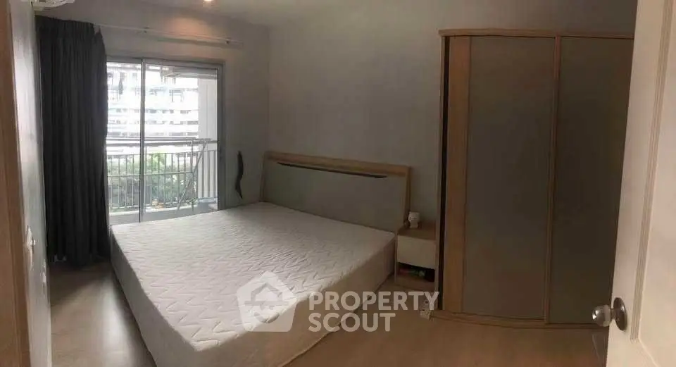 Cozy bedroom with balcony access and modern wardrobe