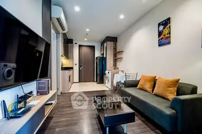 Modern living room with sleek furniture and integrated kitchen appliances