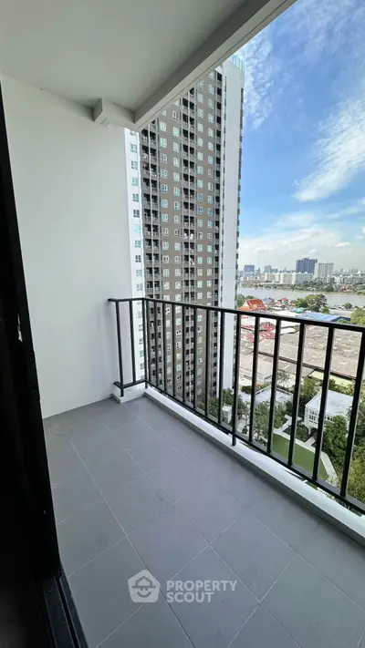 Spacious balcony with stunning city view in modern high-rise apartment