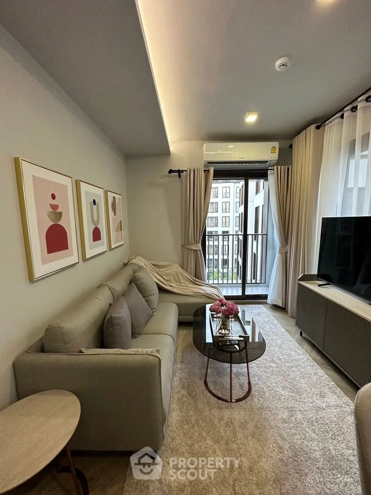 Modern living room with stylish decor and balcony view in urban apartment