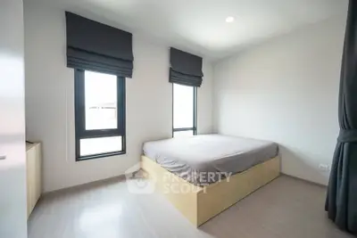 Modern minimalist bedroom with large windows and sleek design