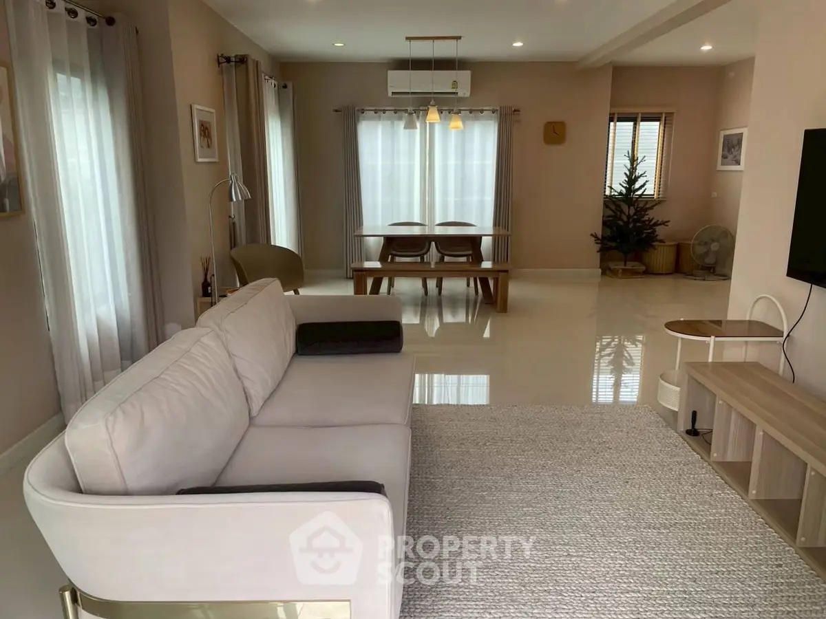Spacious modern living room with elegant decor and ample natural light, perfect for relaxation and entertainment.